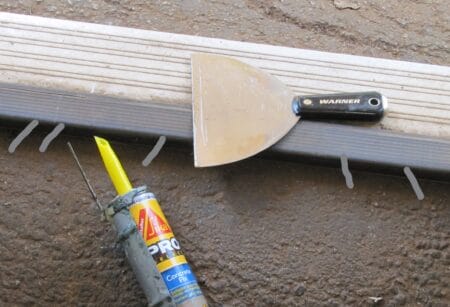 stsfloorand door lip - UrbanSurvival tubes of concrete patch fill the gap